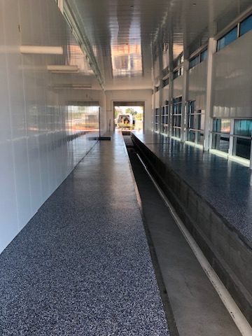 Flake epoxy floor on a covered exterior walkway in Naples, FL
