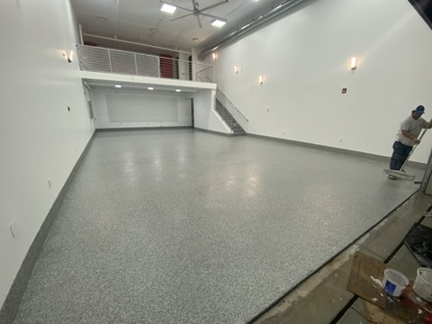 Gray flake epoxy floor in a retail unit with a mezzanine in Naples, FL