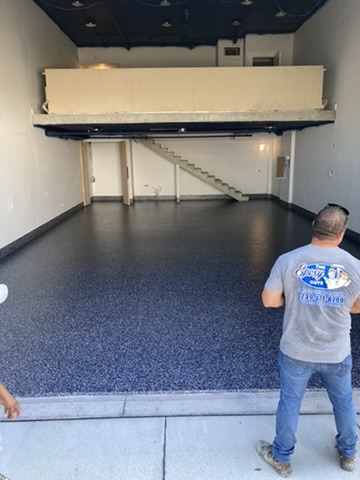 Navy and gray flake epoxy floor in a commercial unit in Naples, FL