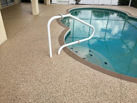 Textured anti-slip pool deck coating around a swimming pool in Naples, FL