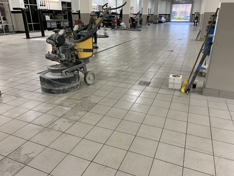 Concrete floor being ground in a dealership service area in Naples, FL