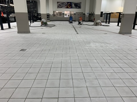 Concrete floor being mechanically ground in a showroom in Naples, FL