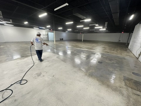 Concrete floor being prepped for polishing in a warehouse in Naples, FL