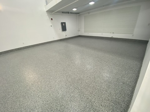 Residential garage in Cape Coral, FL with a gray flake epoxy floor coated out to the door line